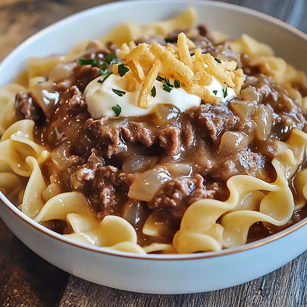 A bowl of pasta with meat and cheese.