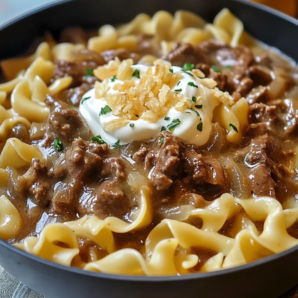 A bowl of pasta with meat and cheese.