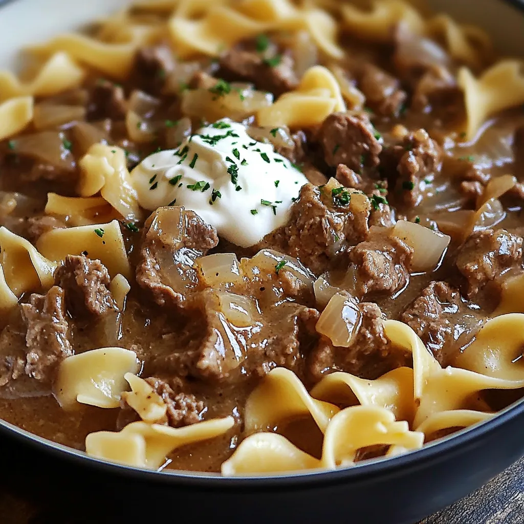 A bowl of pasta with meat and cheese.