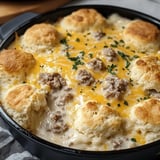 A pan of food with a cheese and meat topping.